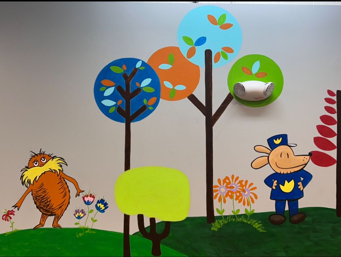 Mural with cute animal characters including the Lorax and a dog