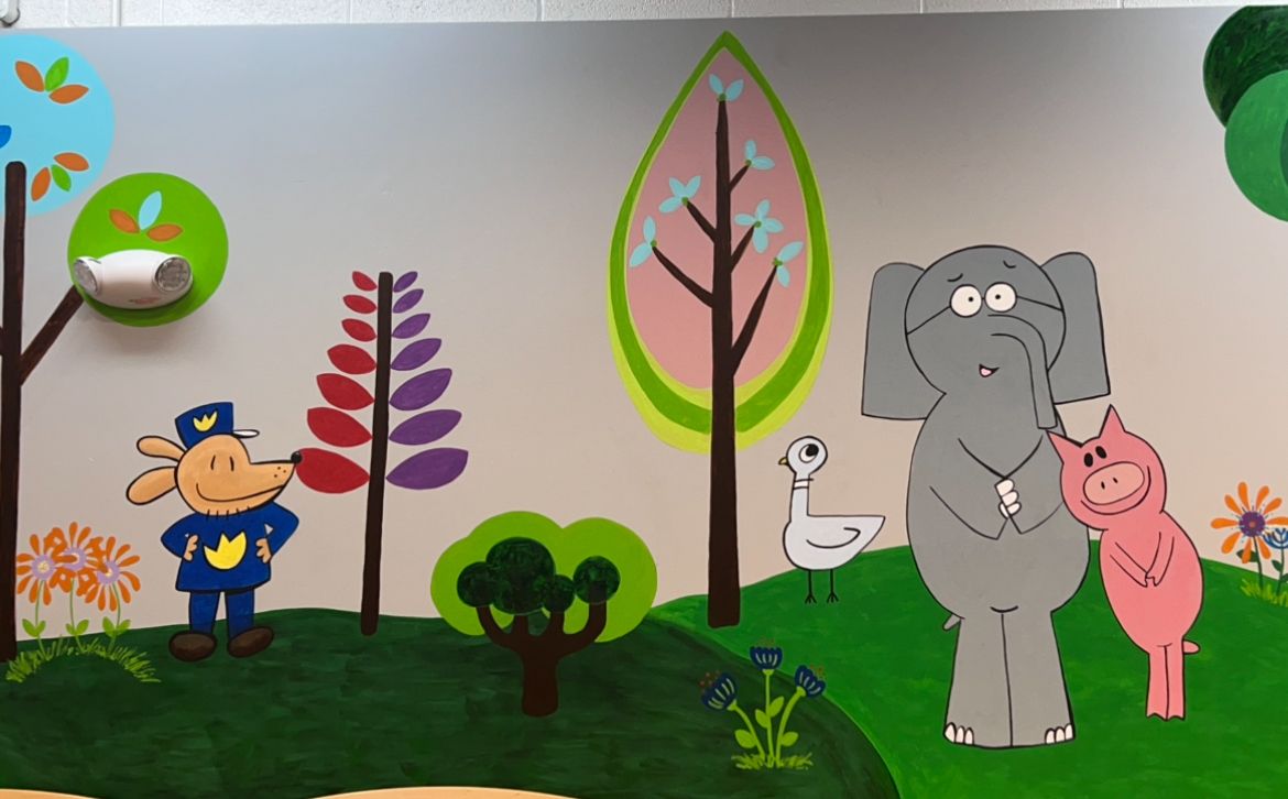 Mural with cute animal characters including a dog, elephant and pig